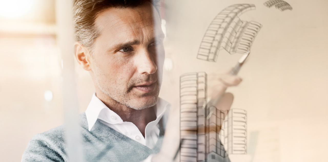 Technical illustrator drawing on a glass board