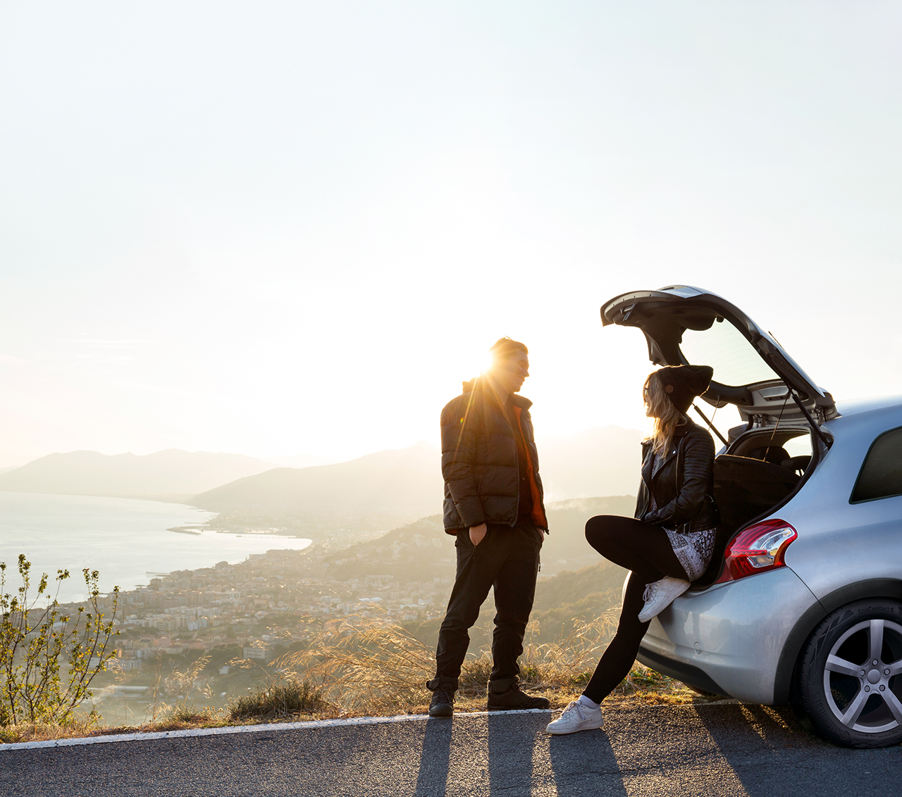 A couple takes a break at a road trip.