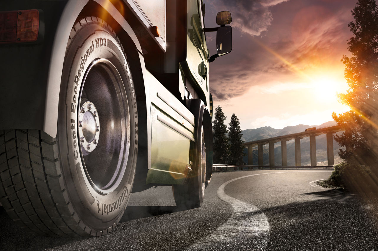 A man from the Conti360 Breakdown service inspects a truck tire